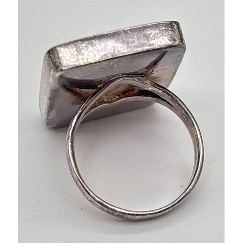 1040 - A large square shaped 925 silver dress ring set with abalone shell. Stamped 925 inside band. Size S.