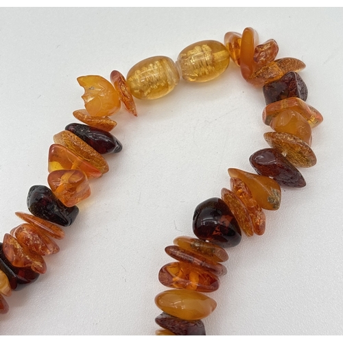 1044 - A vintage amber chip necklace with screw barrel clasp, made from chips of cherry, cognac and honey a... 