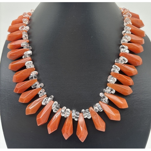 1049 - A large carnelian and rock crystal  statement necklace with spring ring silver clasp. Made from alte... 