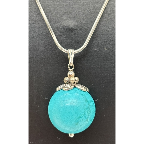 1058 - A turquoise ball pendant on an 18