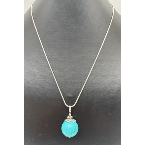 1058 - A turquoise ball pendant on an 18