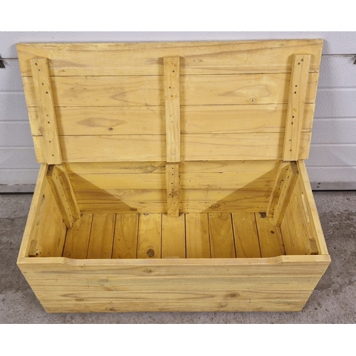 1380 - A vintage slatted pine box, painted yellow, with hinged lid and cut-out handles. Approx. 37.5cm tall... 