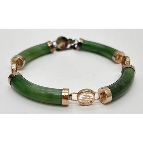 1071 - A green jade bracelet made with 4 panels with alternating gilt metal Chinese character links. Push c... 