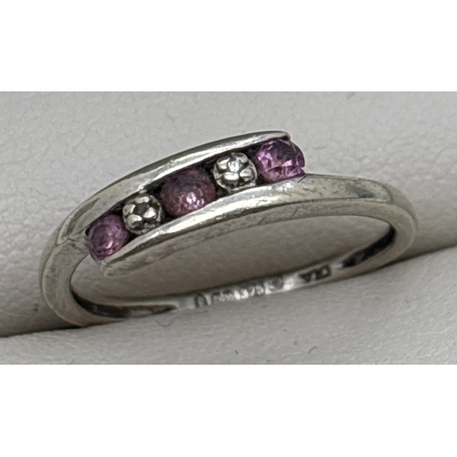 1091 - A 9ct white gold, pink sapphire and diamond crossover ring set with 3 small round cut sapphires & 2 ... 