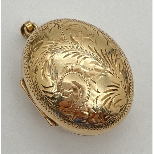 1093 - A large 9ct gold oval bulbous shaped locket with floral engraved pattern front and back. Hallmarked ... 