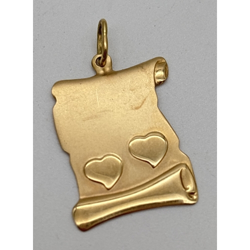 1098 - A 9ct gold scroll shaped pendant with 2 embossed love hearts. Stamped 375 on bale. Total weight appr... 