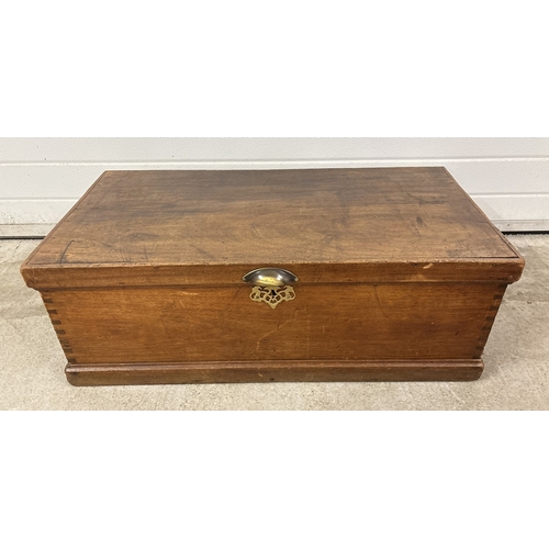 1385 - An antique blanket box with modern brass cup handle, Key escutcheon and handles on ends. Approx. 32 ... 