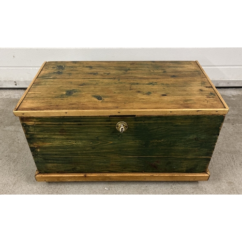 1390 - A small vintage pine box with green painted detail. With hinged lid and with drop handles on ends. A... 