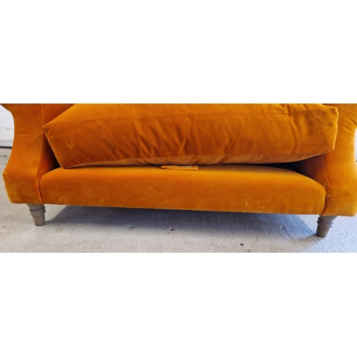 1392 - A modern wide seated low armchair with orange velvet upholstery and wooden feet. With fire labels, m... 