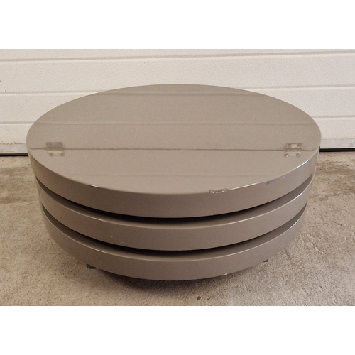 1393 - A modern Triplo high gloss rotating coffee table, in grey. Approx. 32cm tall x 80cm diameter. Small ... 