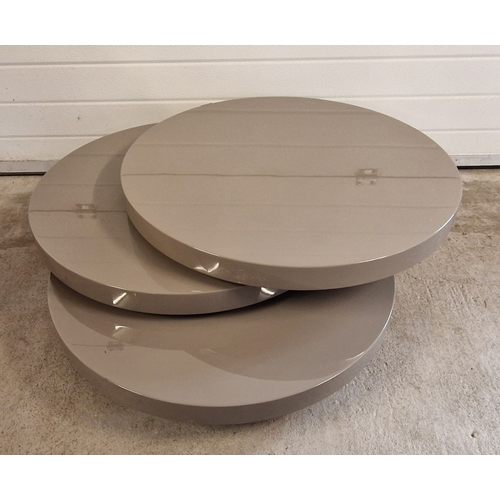 1393 - A modern Triplo high gloss rotating coffee table, in grey. Approx. 32cm tall x 80cm diameter. Small ... 