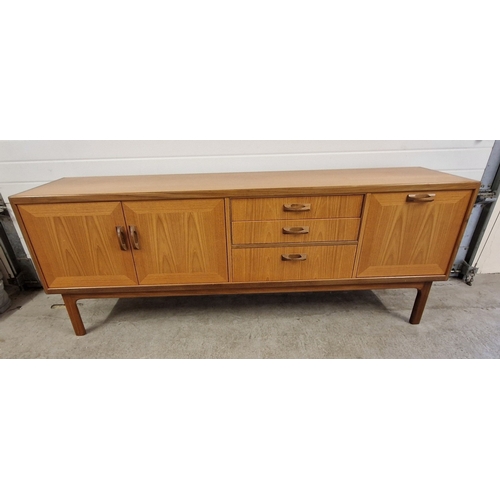 1398 - A vintage mid century G Plan teak sideboard with hooped wooden handles. Baize lined cutlery drawer, ... 