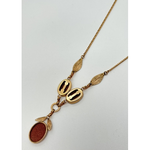 10 - A vintage Van Dell 12k gold filled fixed pendant necklace set with oval cut goldstones with leaf dec... 