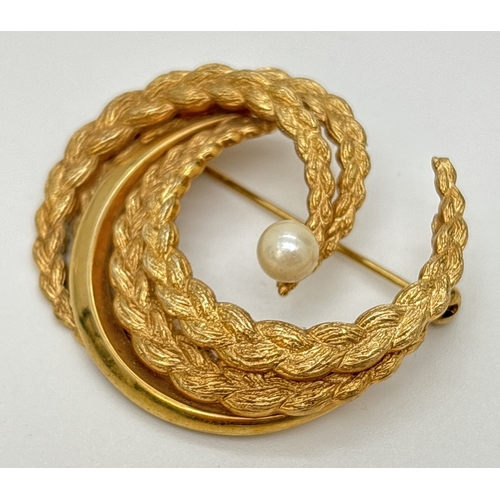 20 - A 9ct gold vintage style brooch set with a single cultured pearl. Intertwined semicircles in a plain... 