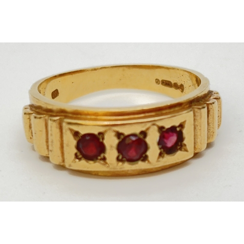 47 - A vintage 9ct gold band ring set with 3 round cut garnets and stepped detail to shoulders. Gold mark... 