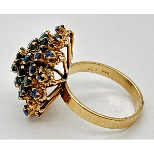 132 - A vintage 14ct yellow gold sapphire set cluster statement ring. 3 rows of round cut stones with 2 ce... 