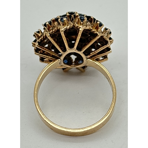 132 - A vintage 14ct yellow gold sapphire set cluster statement ring. 3 rows of round cut stones with 2 ce... 