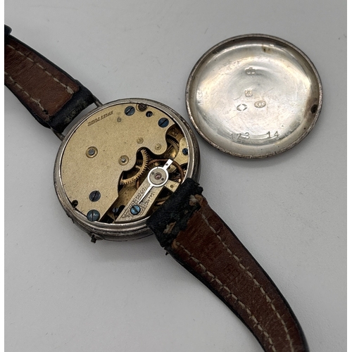 1146 - A silver cased vintage wristwatch with white enamel face and brown leather strap. Silver marks to in... 