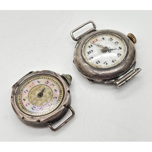 1148 - 2 antique silver wristwatches without straps. A round cased watch with white enamel face, black hour... 