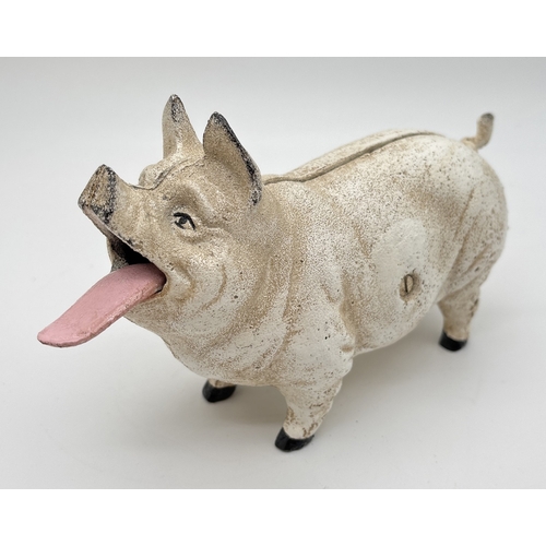 1199 - A painted cast iron mechanical money bank modelled as a pig with moving tongue and tail. Approx. 12c... 