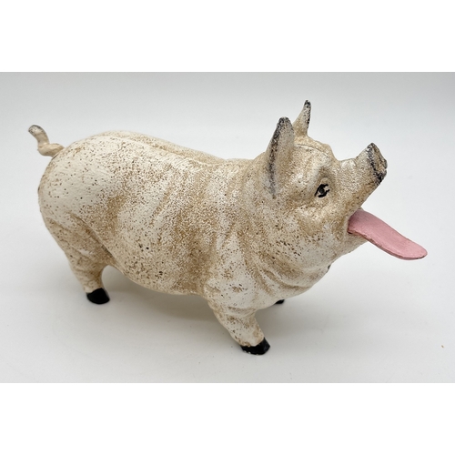 1199 - A painted cast iron mechanical money bank modelled as a pig with moving tongue and tail. Approx. 12c... 