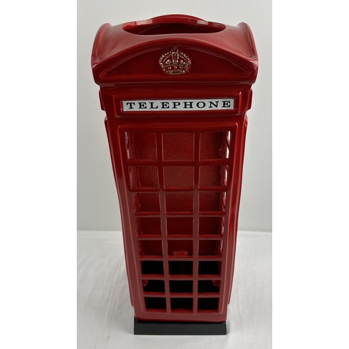 1203 - A modern painted cast metal stick stand modelled as a vintage red telephone box. Approx. 57cm tall.