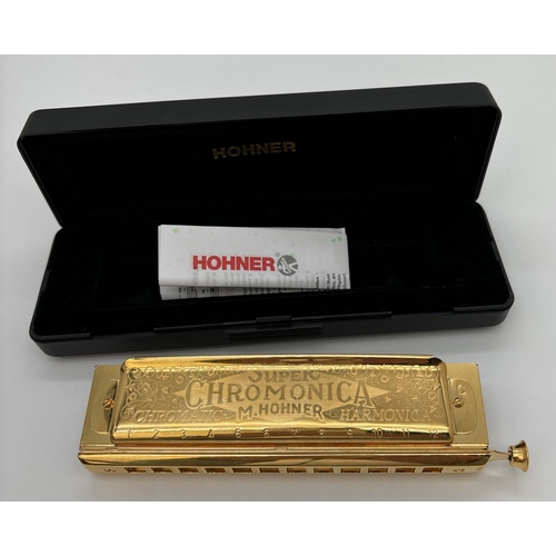 1270 - A cased Super 270 Chomonica Chromatic Harmonica by Hohner in a gold tone finish. In the key of C. En... 