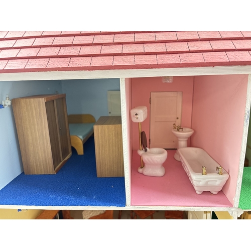 1281 - A large wooden fully furnished dolls house with red brick finish. Fully fitted with electrical light... 