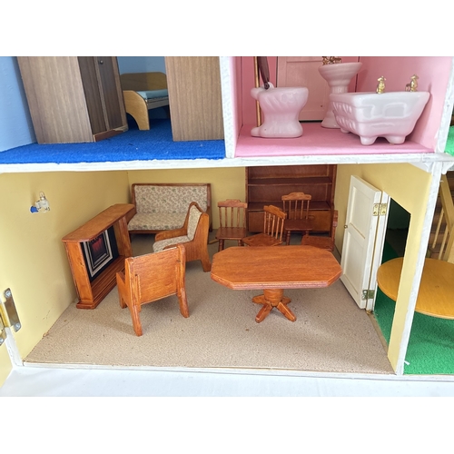 1281 - A large wooden fully furnished dolls house with red brick finish. Fully fitted with electrical light... 