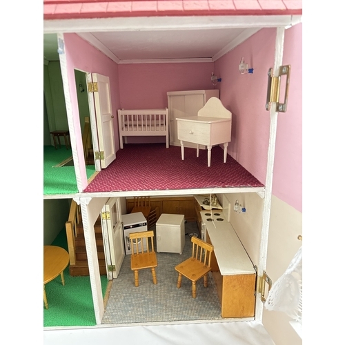 1281 - A large wooden fully furnished dolls house with red brick finish. Fully fitted with electrical light... 