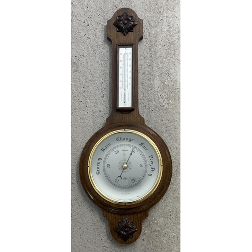 1319 - A large vintage dark wood Shortland Smiths banjo barometer with thermometer. Carved applied panels t... 