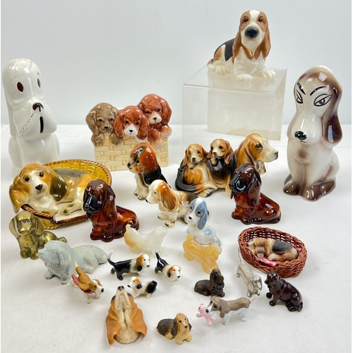 1226 - A collection of ceramic, metal, natural stone and resin figures of mostly Basset hounds in varying s... 