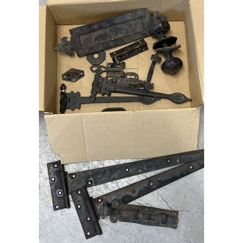 1190 - A box of vintage painted black metal hardware for doors. To include pairs of hinges, a letter box, s... 