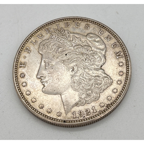 1 - An American 1921 silver Morgan dollar coin with mint mark for Denver. Lady Liberty to obverse, desig... 