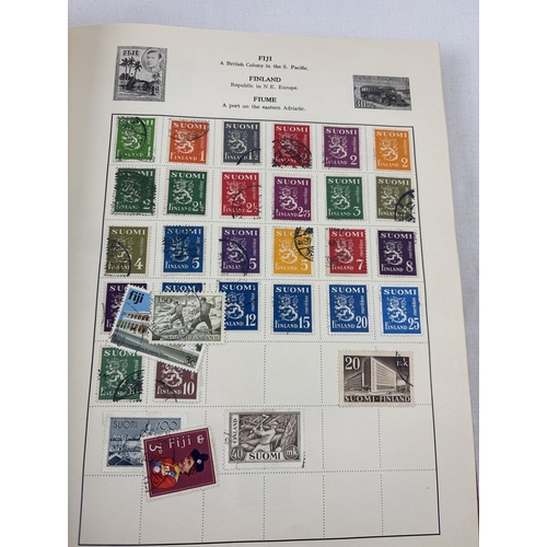 40 - A vintage 1930's Liberty postage stamp album & slip cover containing assorted world stamps.