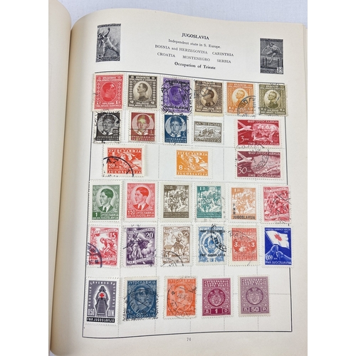 40 - A vintage 1930's Liberty postage stamp album & slip cover containing assorted world stamps.