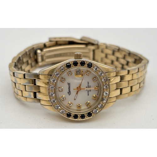 1203 - A ladies Ingersol Gems wristwatch IG0015 with 18ct gold plated case and bracelet strap. White and bl... 