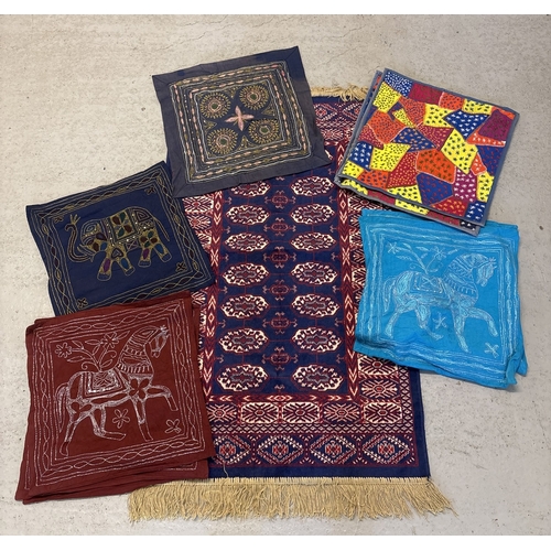 1379 - A box of ethnic style embroidered cotton cushion covers together with a blue, red and white pattered... 