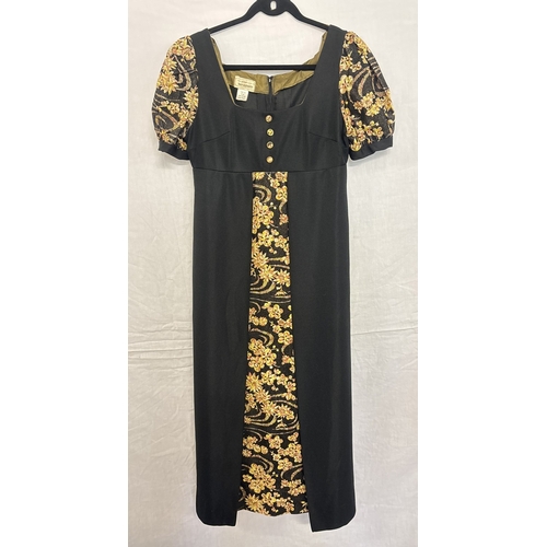 1405 - A 1970's black and yellow floral short sleeve A line maxi dress, size 16. Floral detail to front pan... 