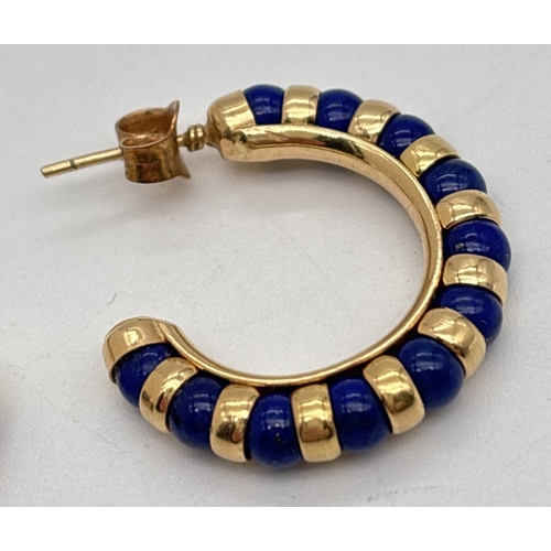 1004 - A pair of 14ct gold and Lapis Lazuli half hoop earrings. Made with alternating gold and lapis lazuli... 