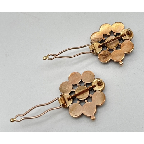 1005 - 2 vintage rose gold garnet set flower design hairclips. Central round cut garnet surrounded by 8 rou... 