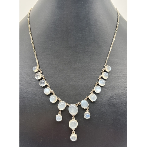 1006 - A vintage silver and moonstone drop style necklace. Figaro style chain with 17 graduating sized roun... 