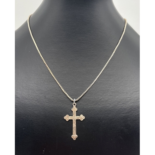 1025 - A vintage silver decorative cross shaped pendant with engraved pattern to front, on a 16