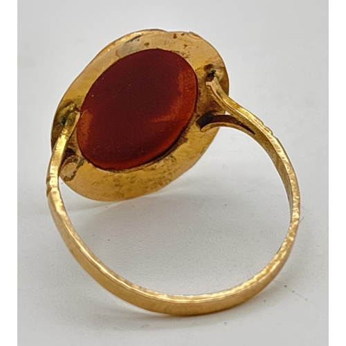 1035 - A yellow metal oval shaped cameo ring with split shoulders and plain shank. Unmarked but tests as 9c... 