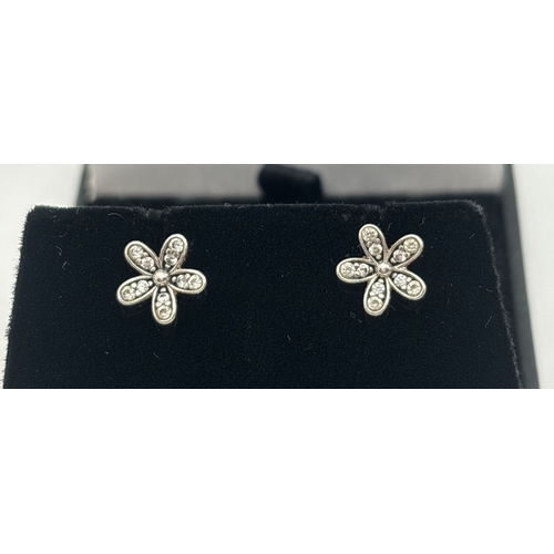 1049 - A pair of Pandora Daisy Flower stud earrings, each set with 10 small round cut clear stones. Pandora... 