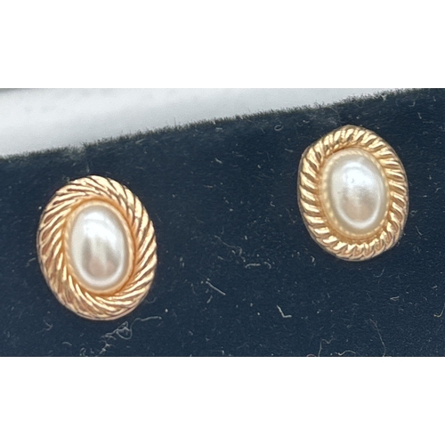 1067 - 2 pairs of yellow metal oval shaped stud style earrings set with faux pearls. With twist design moun... 