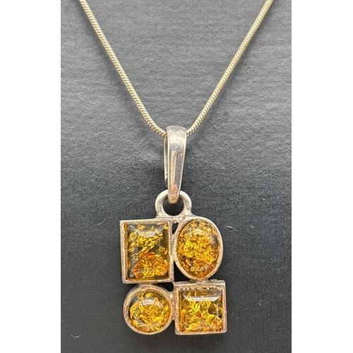 1069 - A silver and green amber modern design pendant necklace with a 20