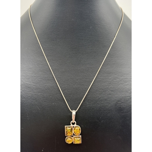 1069 - A silver and green amber modern design pendant necklace with a 20