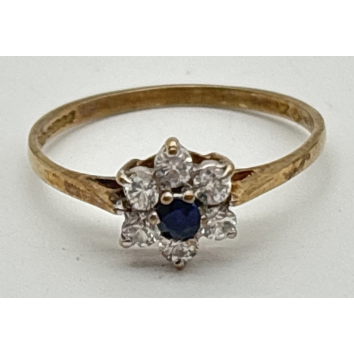 1070 - A 9ct gold, sapphire and cubic zirconia ring with flower head design mount. Small central round cut ... 