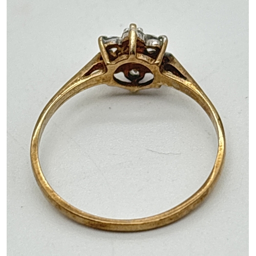 1070 - A 9ct gold, sapphire and cubic zirconia ring with flower head design mount. Small central round cut ... 